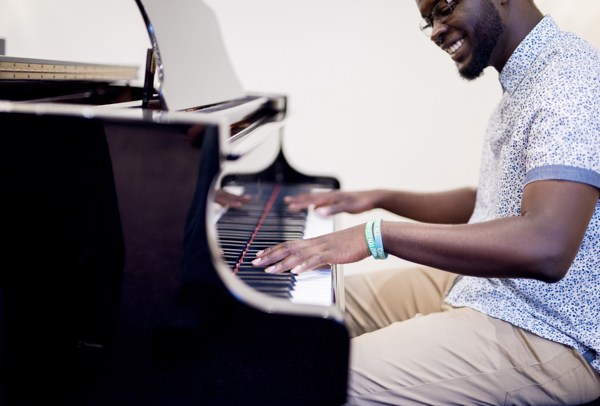 Smiling Black man playing piano